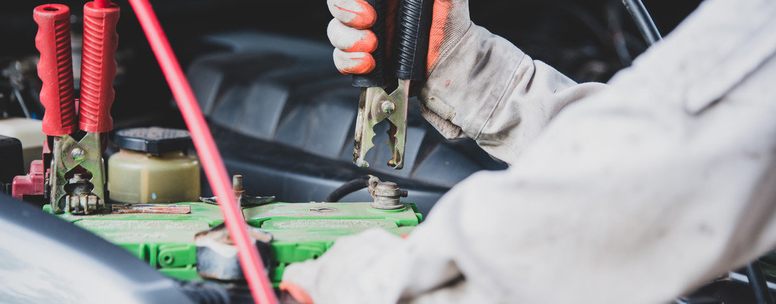 Jumper cables on a car battery
